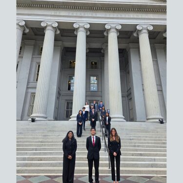 Students stand in front of the U.S. Treasury building